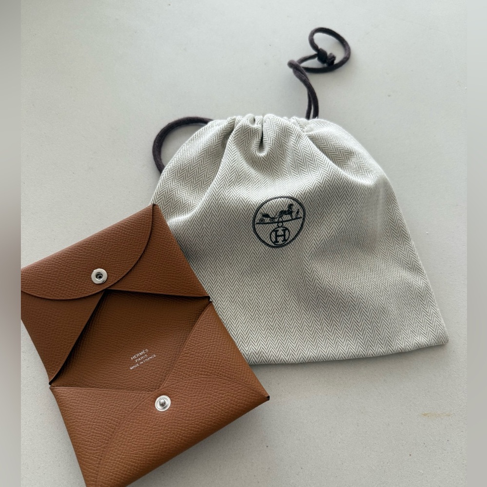 Authentic Hermes  Gold Calvi Card holder w/dustbag. Never used. Like new